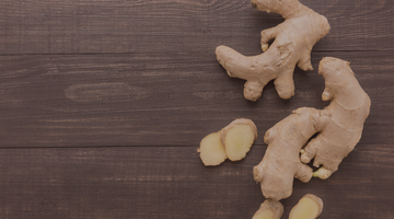 Ginger root laying on a wooden table.