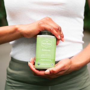 person hold pulp & press kalefornia smoothie wearing fitness clothes