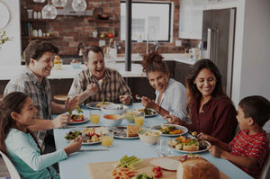 Family enjoying a healthy meal together around a table.