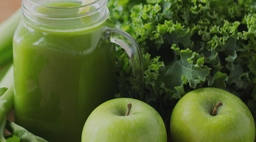 Green fruits and vegetables on a table.