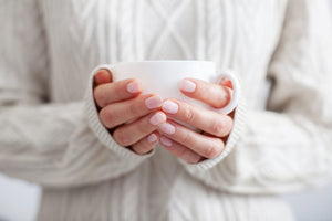 Woman holding coffee mug.