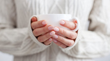 Woman holding coffee mug.