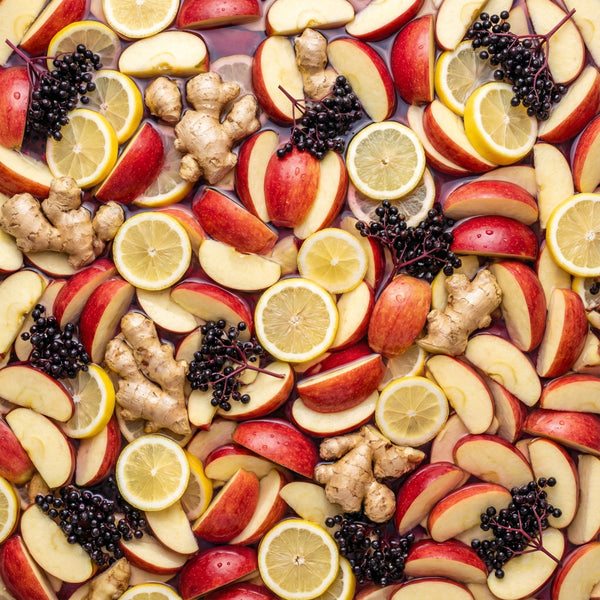 Fruit and ginger slices in a juice bath with lemons, apples, elderberries