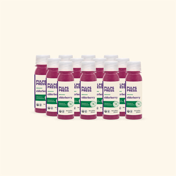 Multiple bottles of Pulp & Press elderberry juice on a white background
