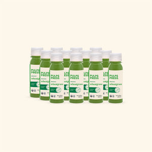 Multiple bottles of Pulp & Press wheatgrass juice on a white background
