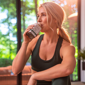 Woman drinking a bottle of hulk 2.0